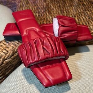 KHAITE Red Leather Slide sandals.